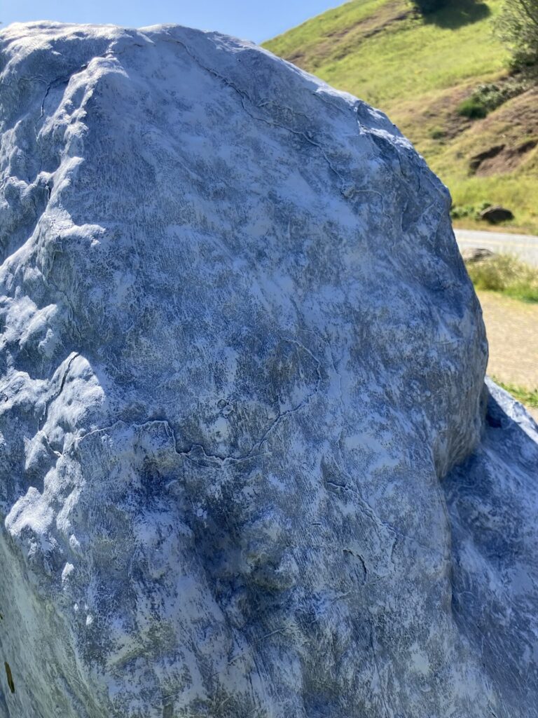 Large rock painted to look like a gray rock. 